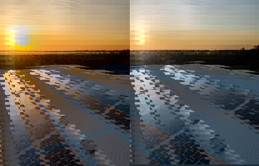 Roof mounted solar panels on an industrial unit at sunset
