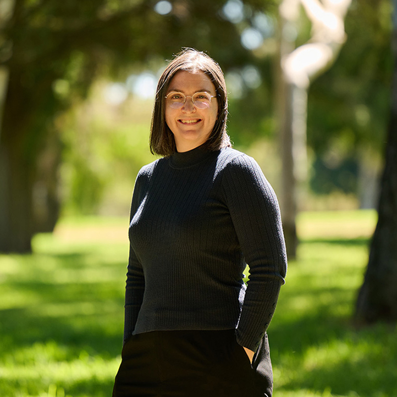 RPS Environmental Consultant, Margaret McCormack smiles at the camera - standing in green grassy field with trees