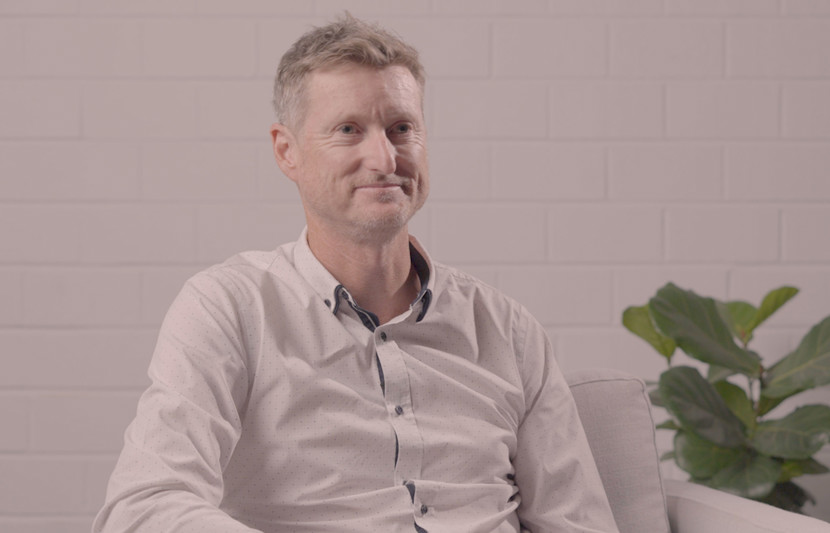 RPS’ Executive Director – MetOcean Science and Technology, Murray Burling sits on an armchair and smiles looking ahead with a pot plant behind him.