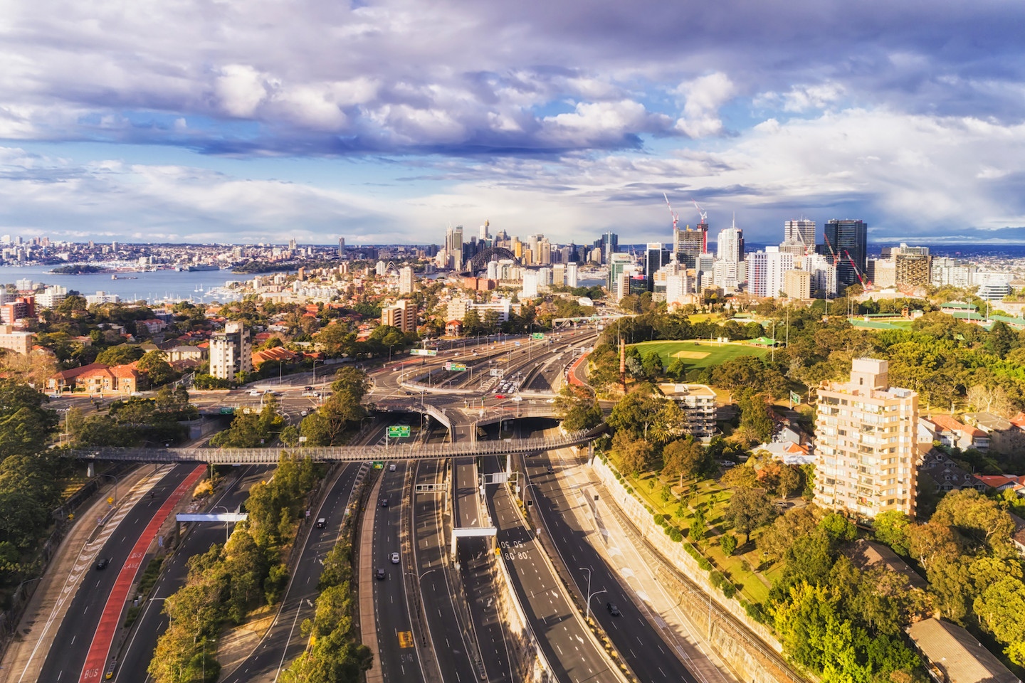 Aerial shot of West Harbour motorway with vehicles driving and the city in the background