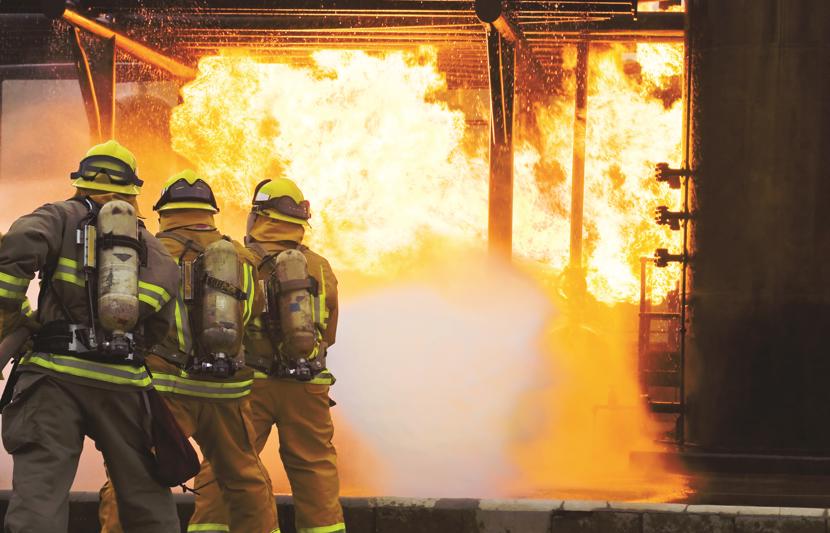 Firefighters putting out flame using new equipment that has transitioned to PFAS-free foam alternatives