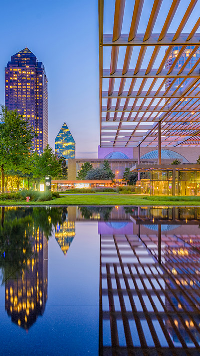 City scape of tall buildings at night built around water 