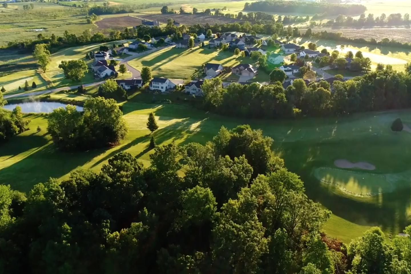 Aerial landscape with housing development surrounded by fields
