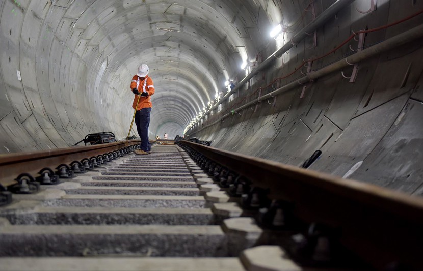 Working inside new Sydney Metro tunnel laying down tracks