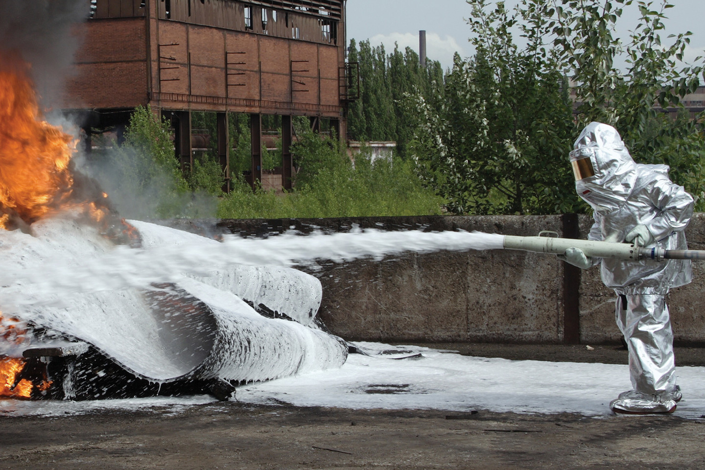 An image of a firefighter extinguishing a blaze. PFAS & PFOS are chemicals given off.