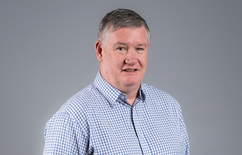 Graham Elgie, RPS General Manager - Geospatial Solutions NSW smiles at the camera wearing blue check shirt