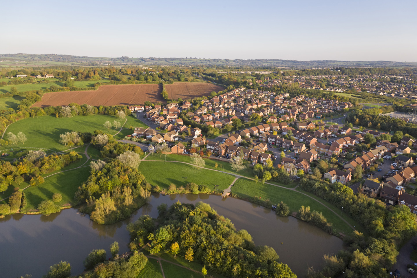 Residential homes near a river and fields