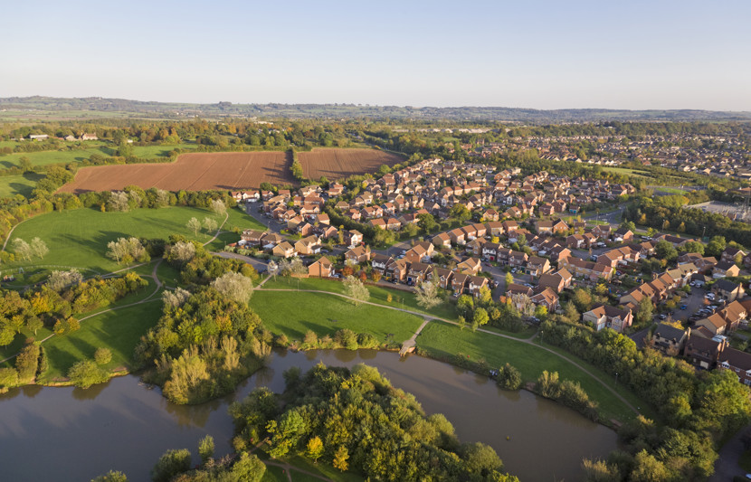 Residential homes near a river and fields