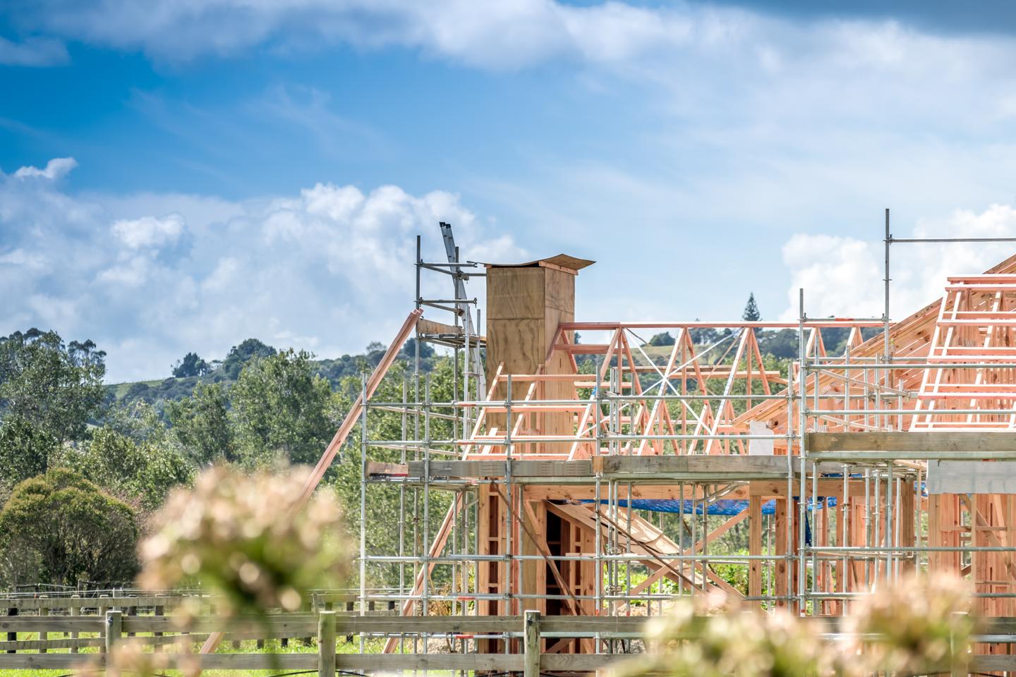 New build house in construction surrounded by green space