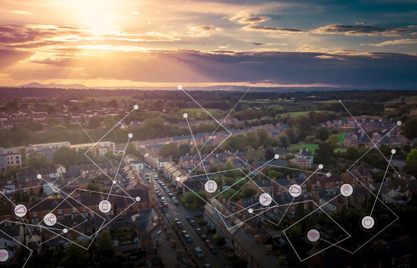 Aerial shot of a residential area and countryside at sunset with interconnected lines overlain