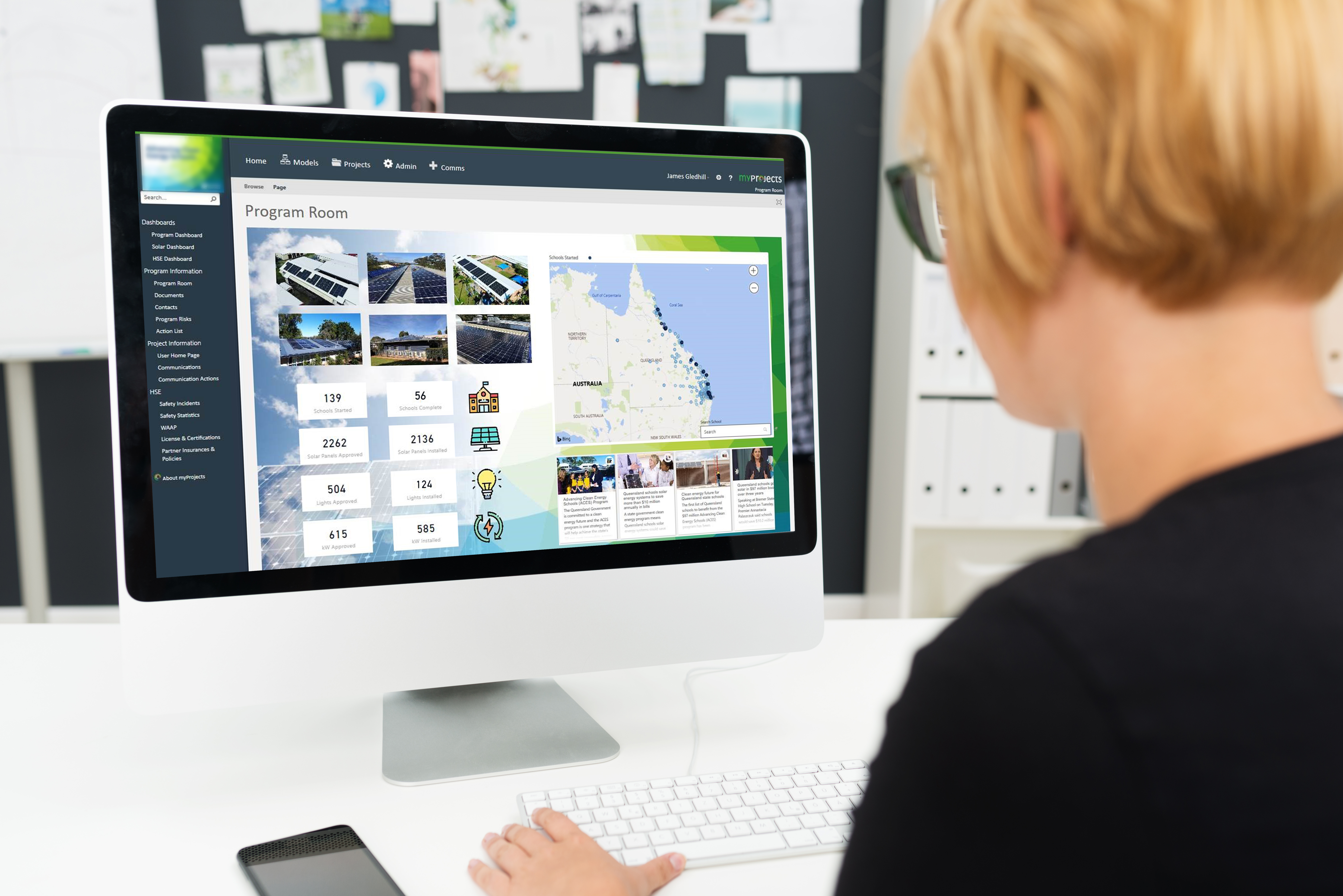 Woman sat at a desktop computer using project management software