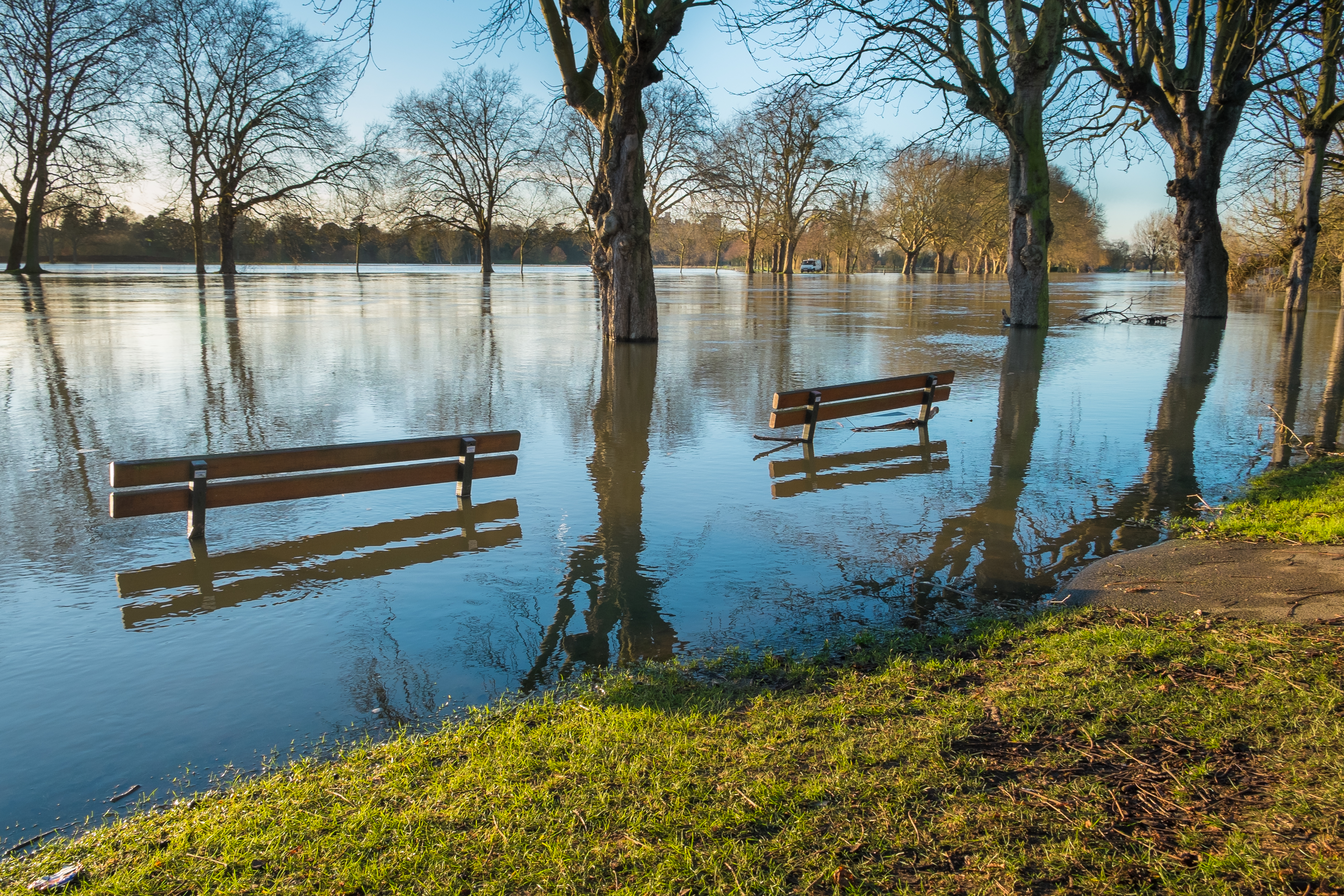 River flooding up embankments and over the top of benches
