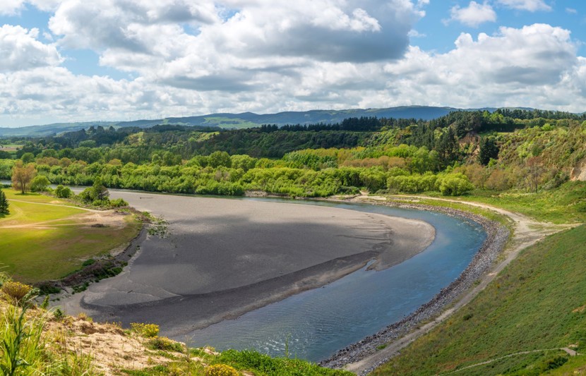 Manawatu river flowing through lush countryside in Palmerston North, New Zealand