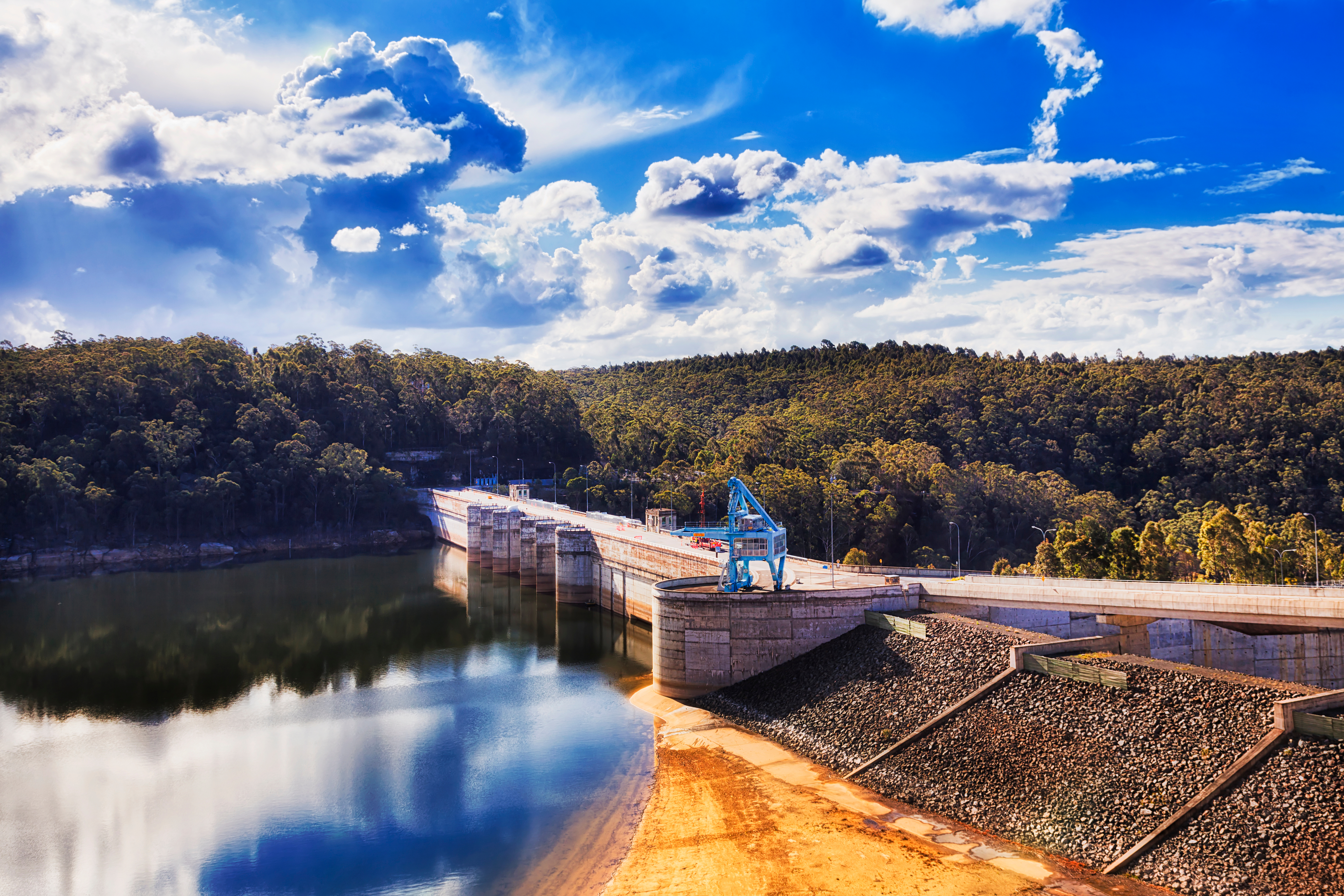 Warragamba Dam with crane. Blue Mountains in the background.