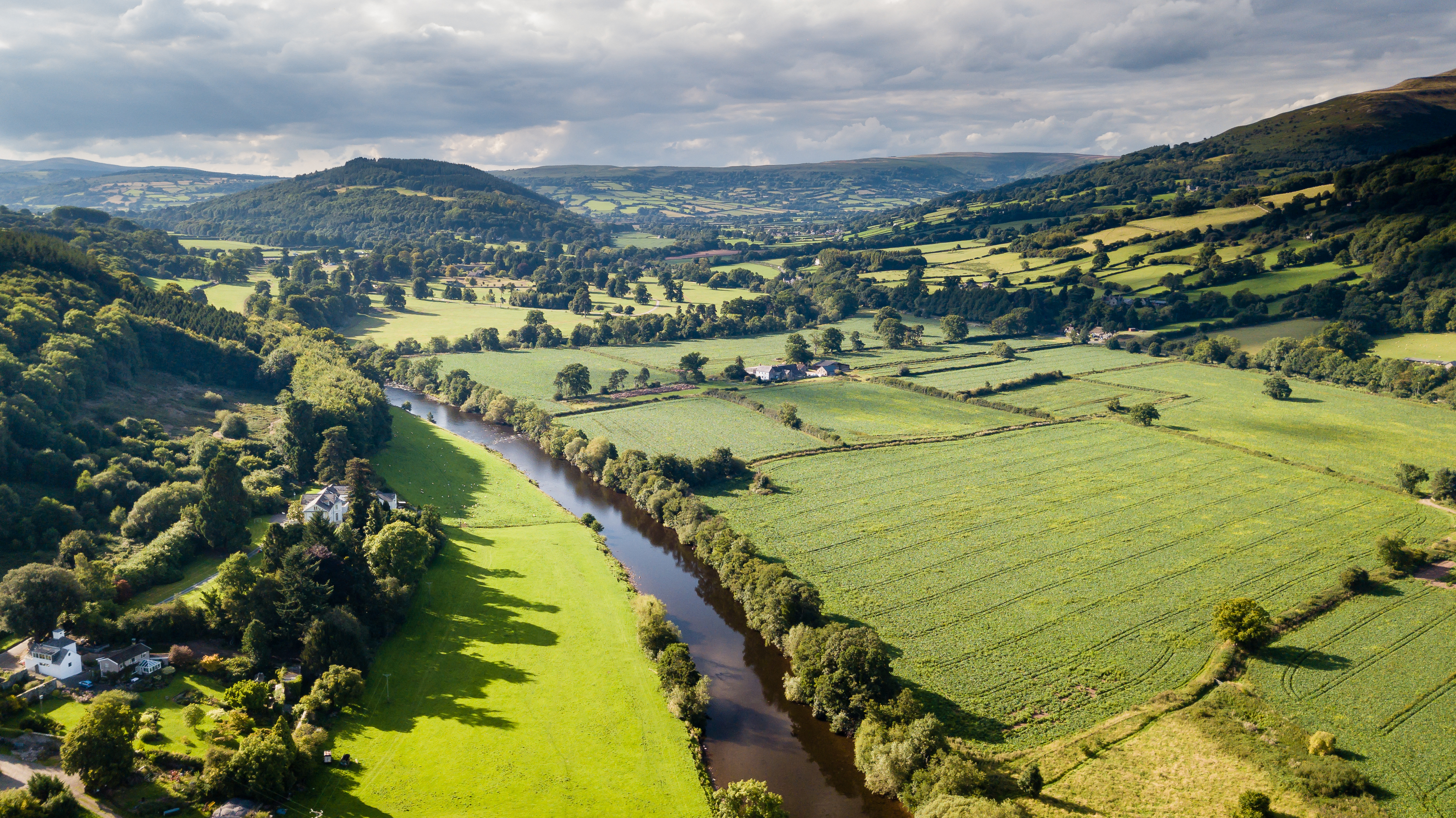 Landscape in the countryside of hills, a river and greenery