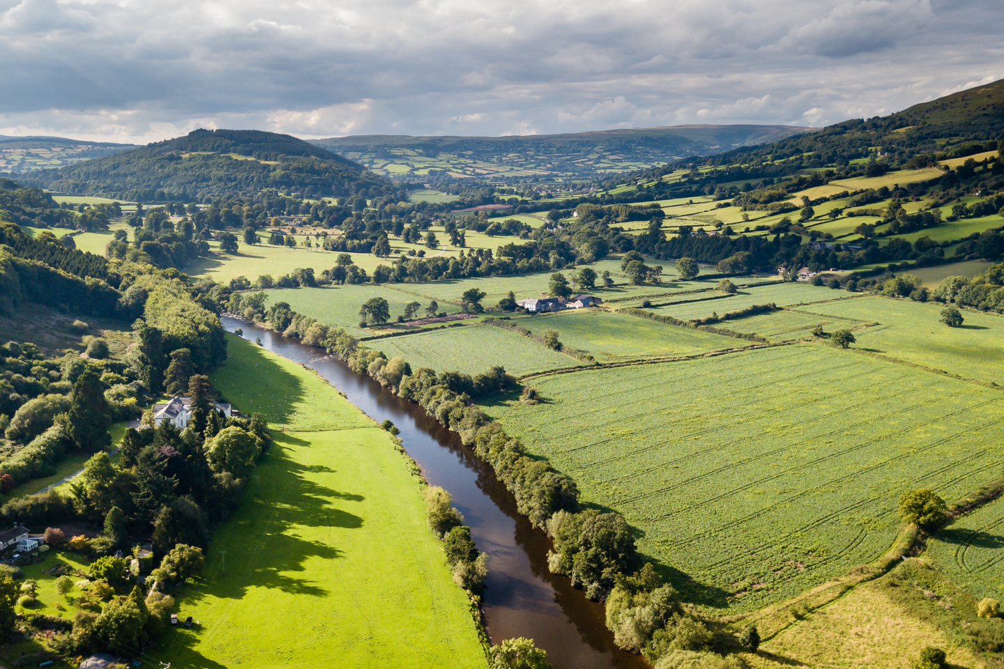 Landscape in the countryside of hills, a river and greenery
