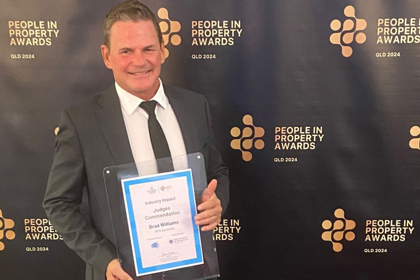 Brad Williams, RPS’ General Manager – Sunshine Coast holds up his judge's commendation in the Industry Impact Award category at the 2024 People in Property Awards. 