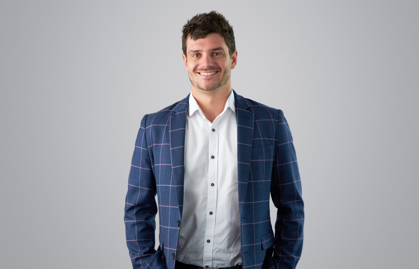 RPS Project Manager Laurence Marin wears blue stripped blazer and white shirt and smiles to camera