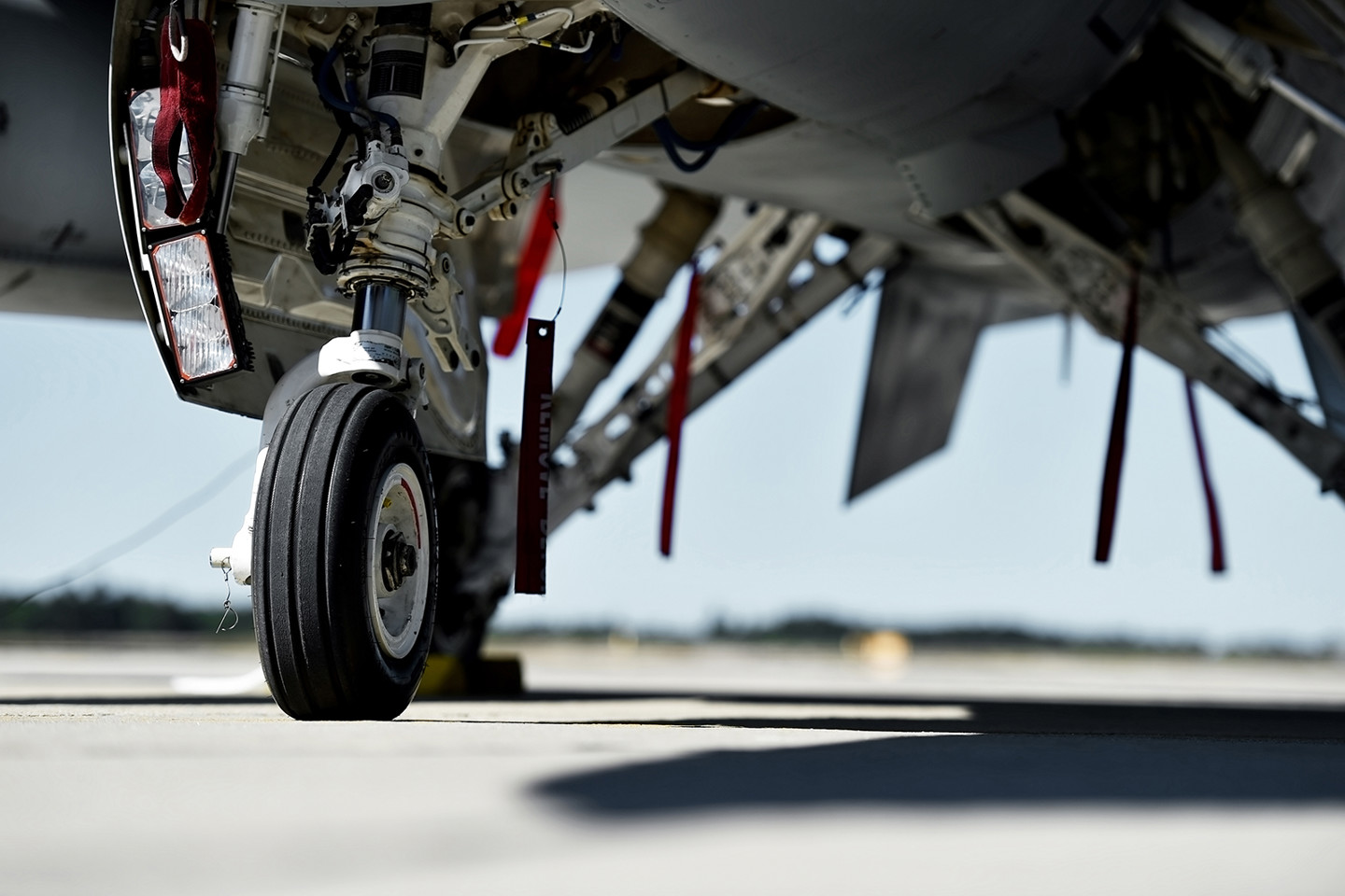 Defence sector expertise RPS
Image: close up of jet landing gear and underside of fuselage of aircraft parked on an Air Force base.