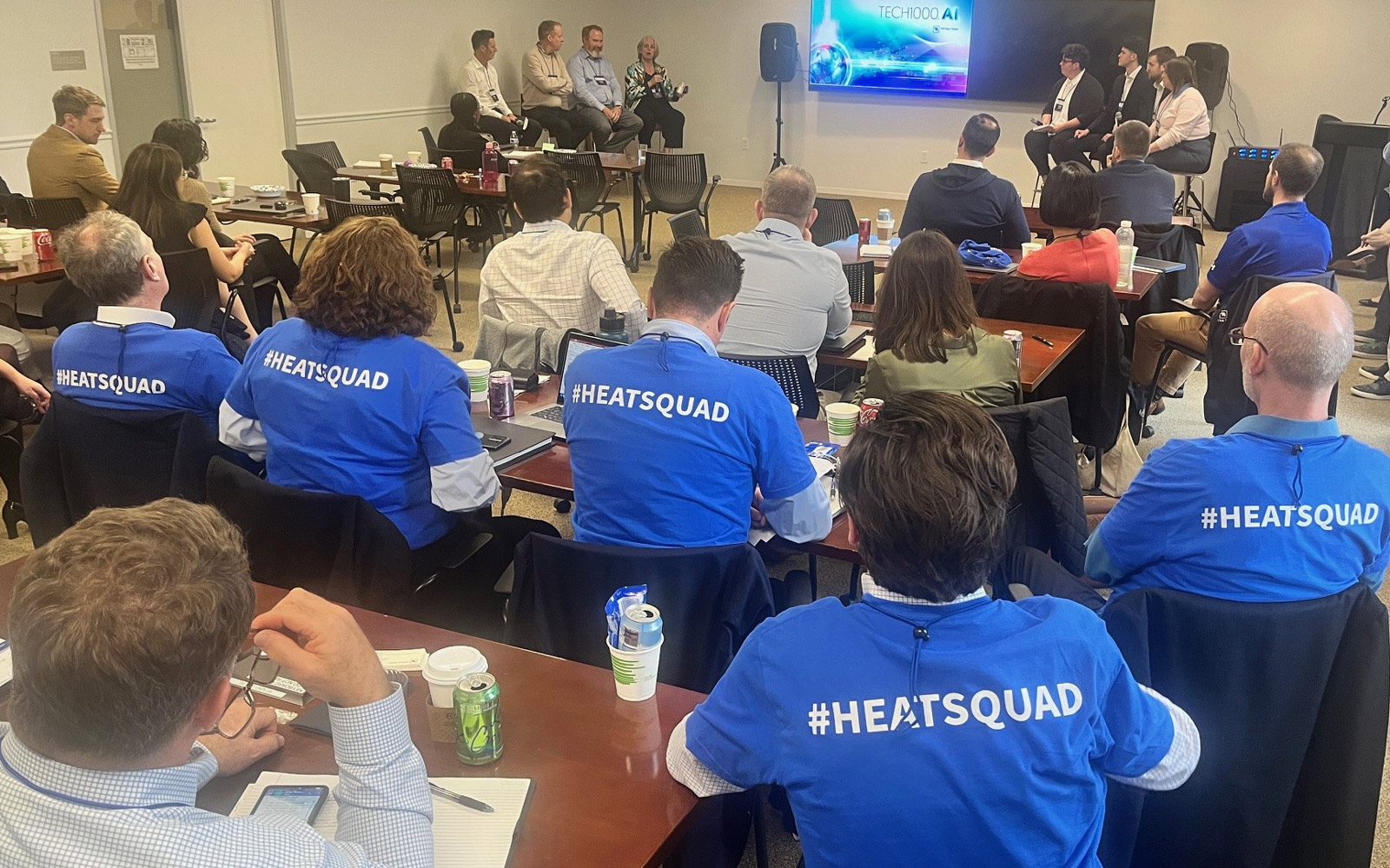 The Heat Squad team sit and listen intently to pitches from other short-listed finalists at the AI.1000 Challenge. 