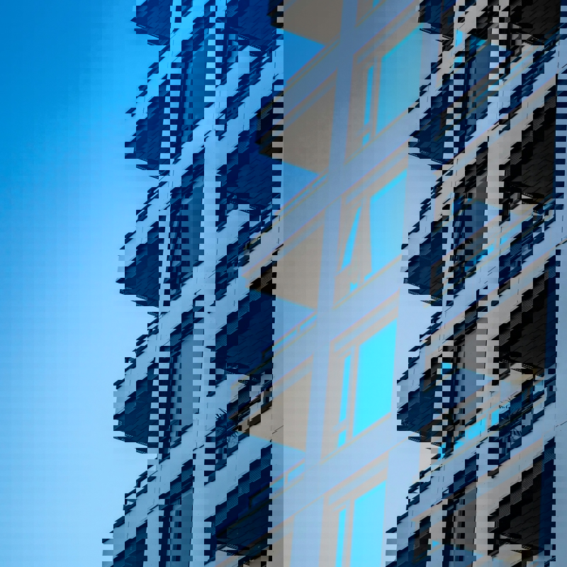 Abstract shot of high rise residential building against blue sky background