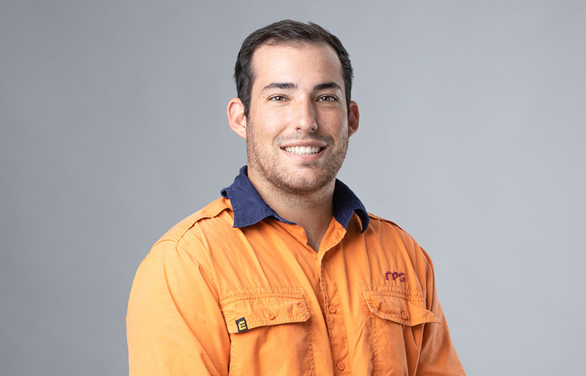 Myles Cassar, Senior Surveyor smiles at the camera wearing high visibility shirt with RPS branding