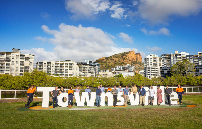Townsville team standing around Townsville sign