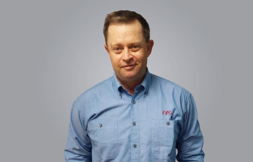 Fletcher Magill, Senior Principal and Practice Lead - Survey, Cairns.
Image: Fletcher smiles at the camera wearing blue chambray shirt.